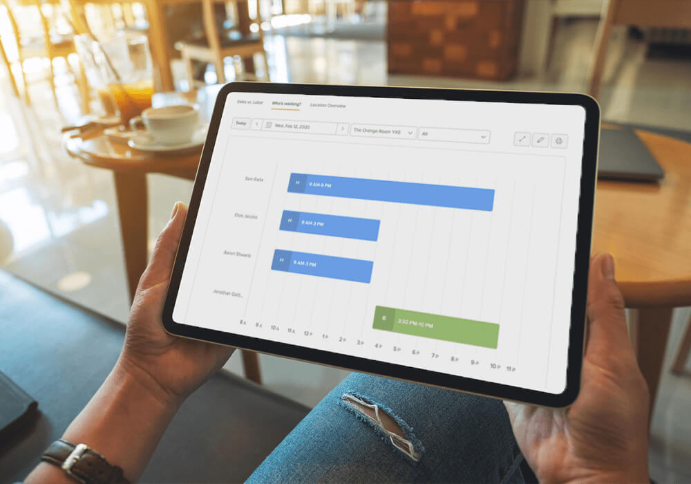 Manager looks at employee scheduling view on tablet