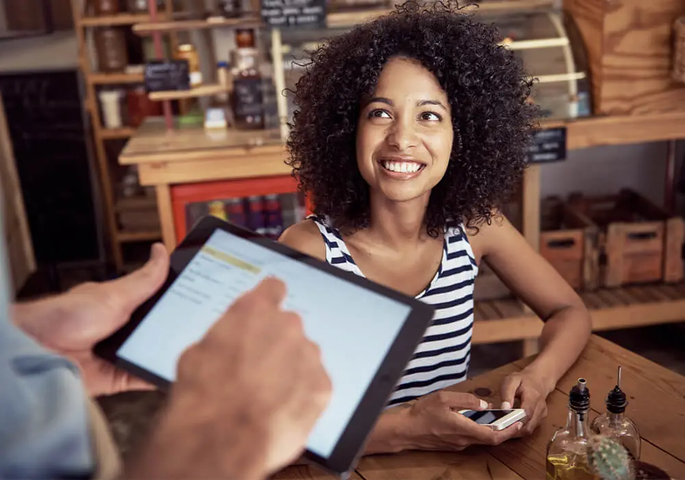 Server takes order tableside with tablet