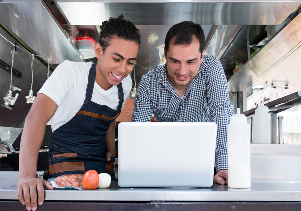Quick Service owner and chef lok at mobile device