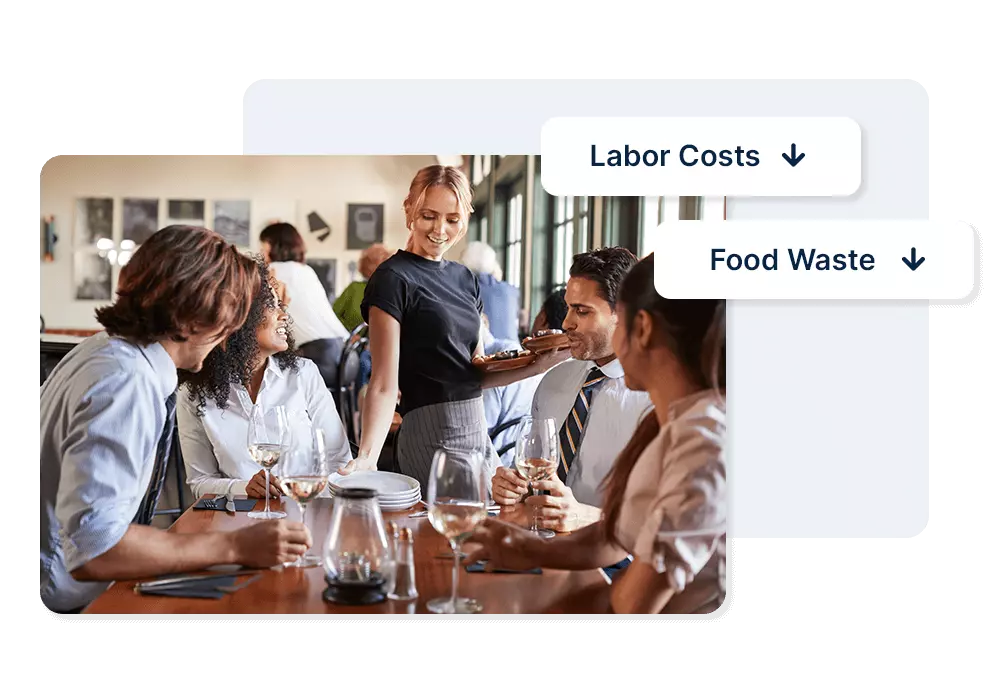 Server delivers food to group of working professionals at table with wine