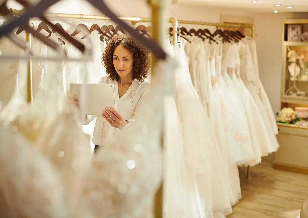 Associate with ipad in wedding dress shop
