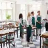 Restaurant manager holding preshift to train servers of iPad pos system service